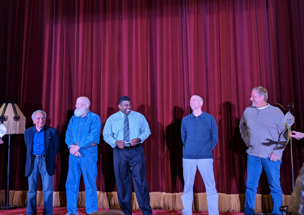 men on stage at a comedy show