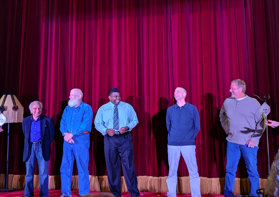 men on stage at a comedy show