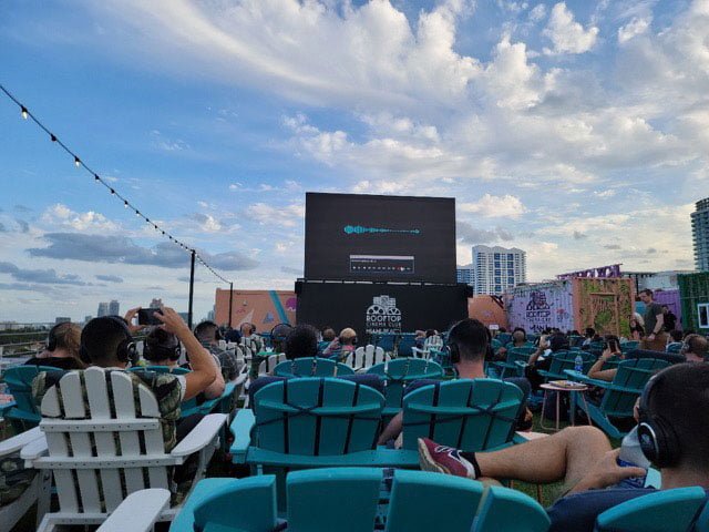 moviegoers at the Rooftop Cinema Club sitting to watch a movie on the screen