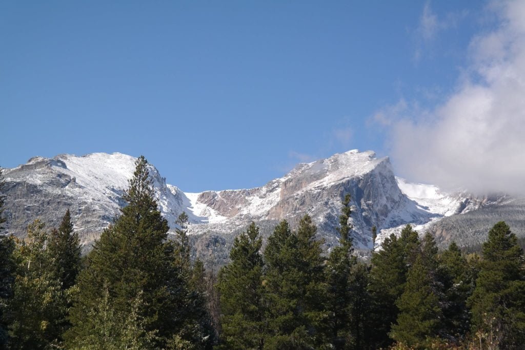 Green Trees Near White and Gray Mountain Under Blue Sky