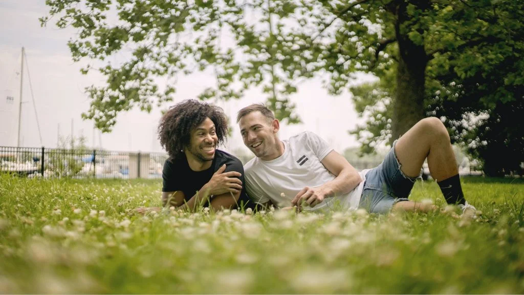 Smiling Men Lying on Grass