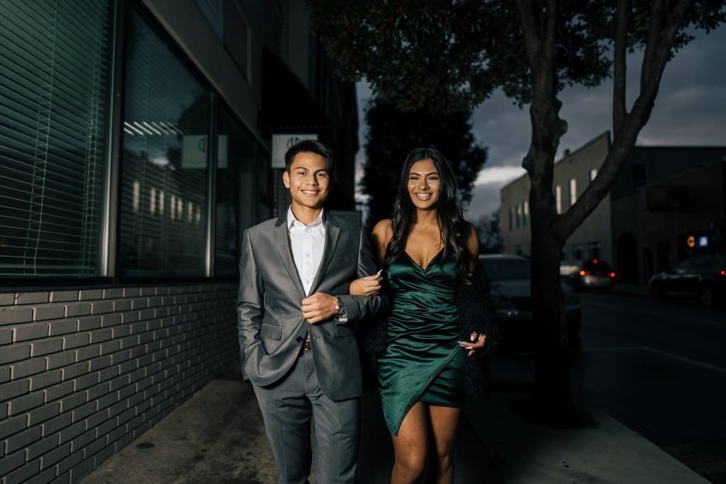 Man in Gray Suit Standing Beside Woman in Green Dress