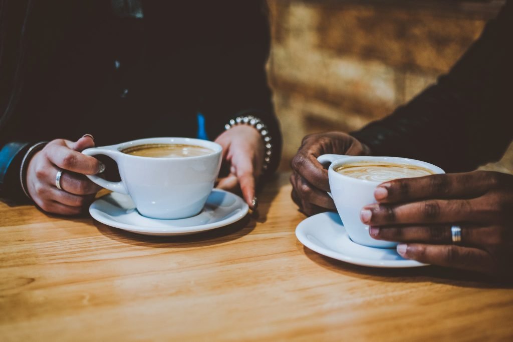 People Holding Mugs