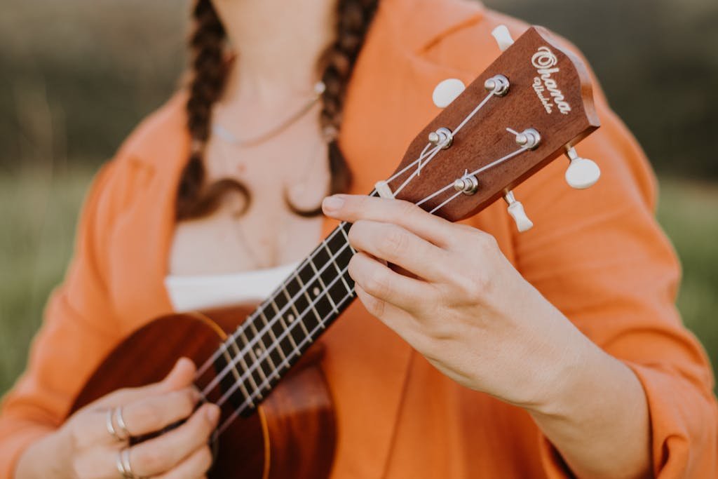 Hands of a Young Woman Playing a Ukulele