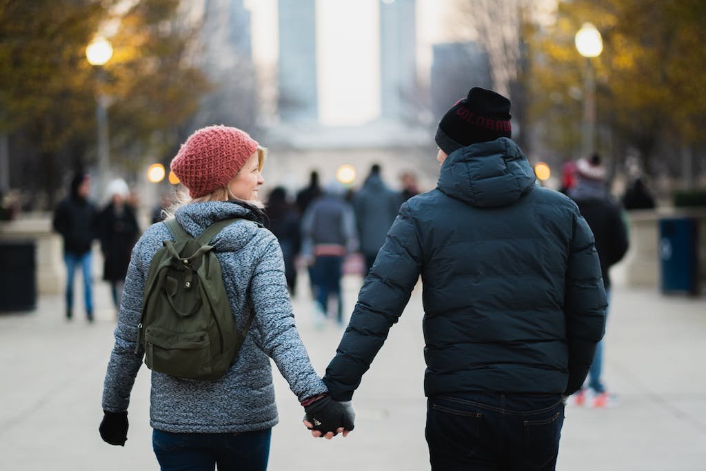 Man and Woman Holding Hands While Walking at Park - alphabet date ideas