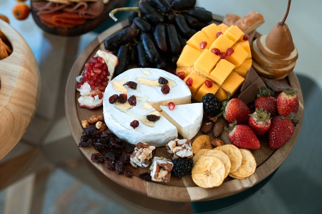 Sliced Cheese and Strawberries on Brown Wooden Plate