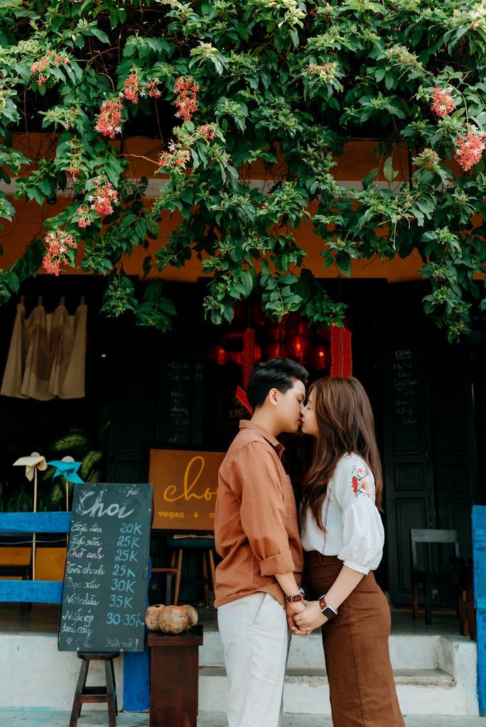 Beloved ethnic teenage coupe kissing on street on sunny day