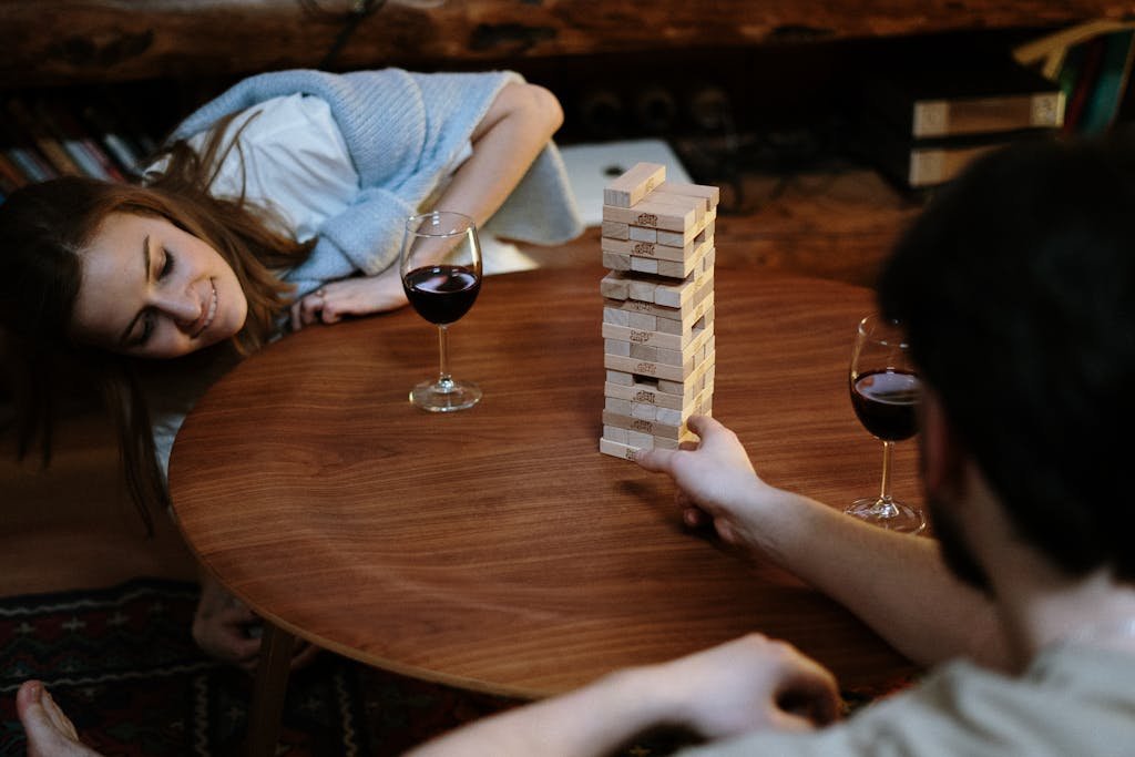 Woman in Blue and White Stripe Shirt Holding Clear Wine Glass