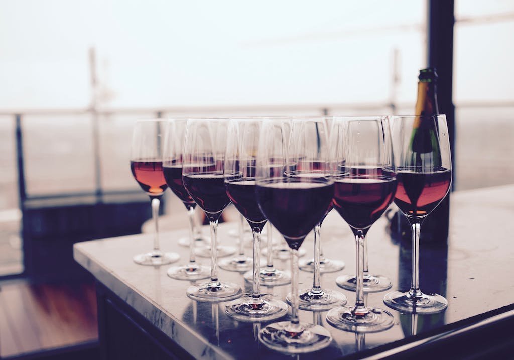 Wine Glass With Red Liquid on Black Table