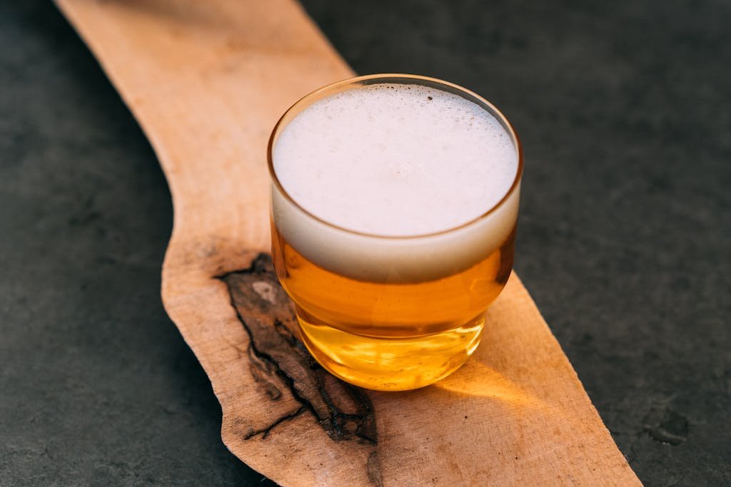 A glass of beer on a wooden board