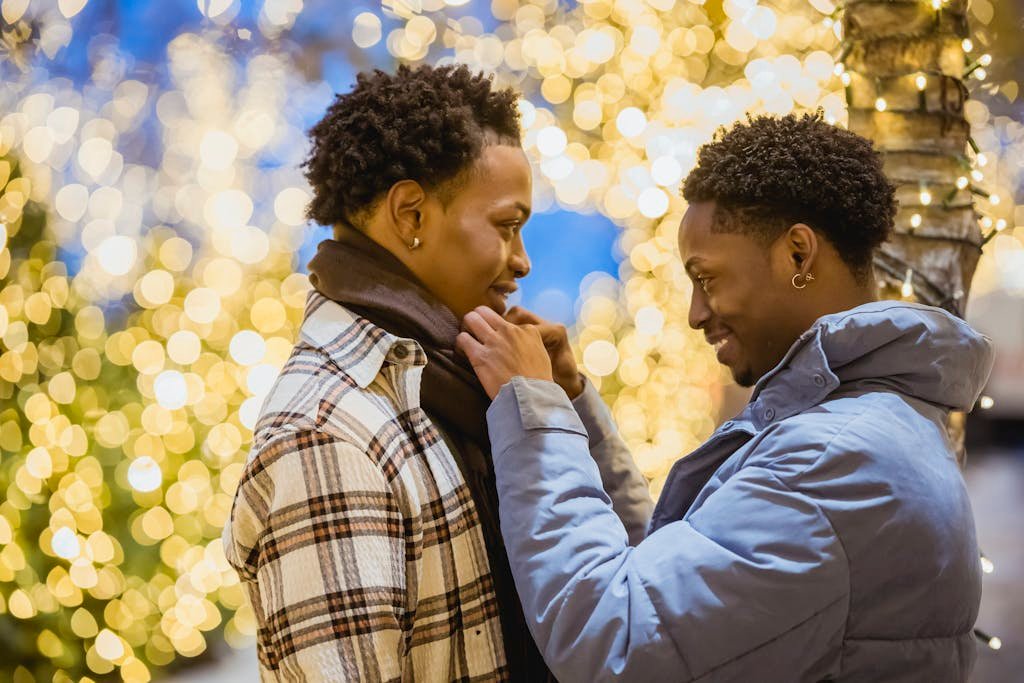 Cheerful black gays on illuminated street