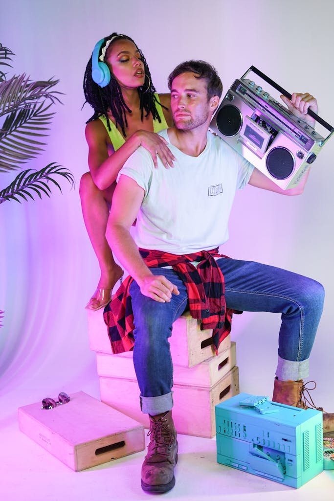 Young Man and Woman Posing with a Vintage Boombox on a Photo Shoot