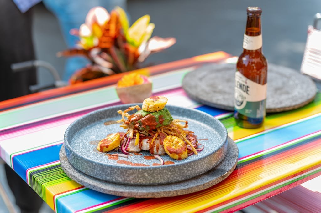 A plate of food sits on a colorful table