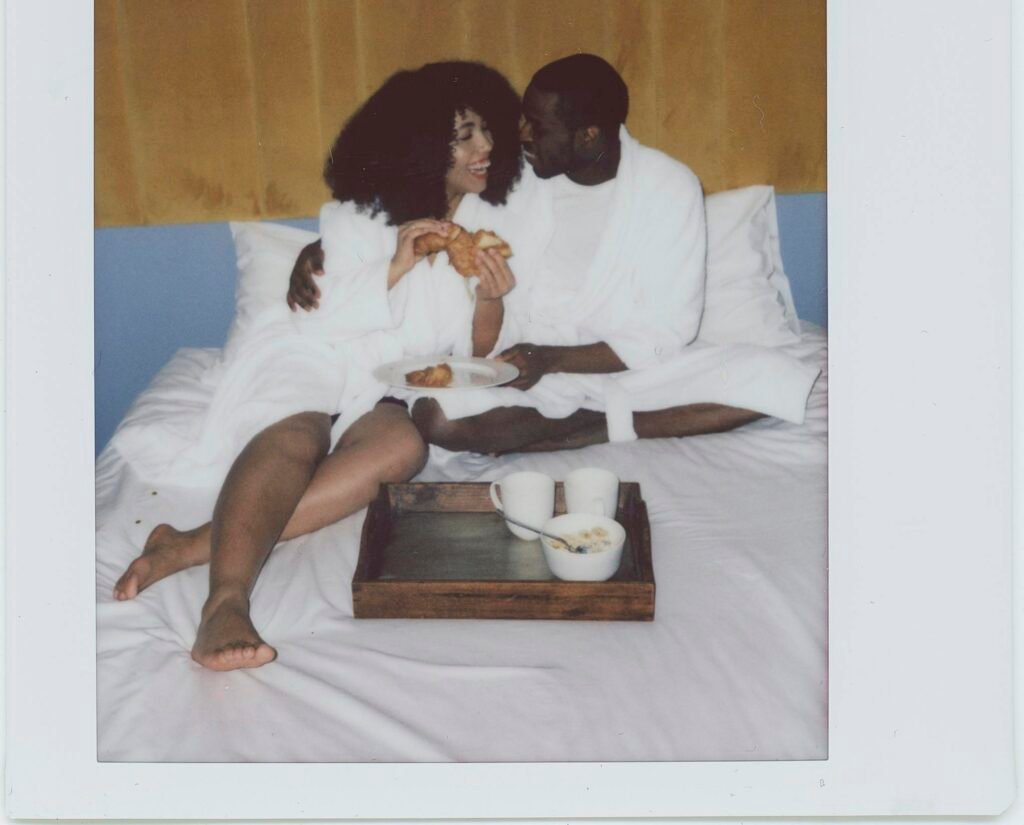 Couple Wearing Bathrobes Having Breakfast in Bed