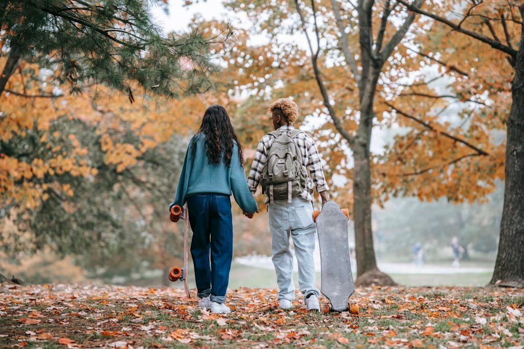 A Couple Carrying Skateboards