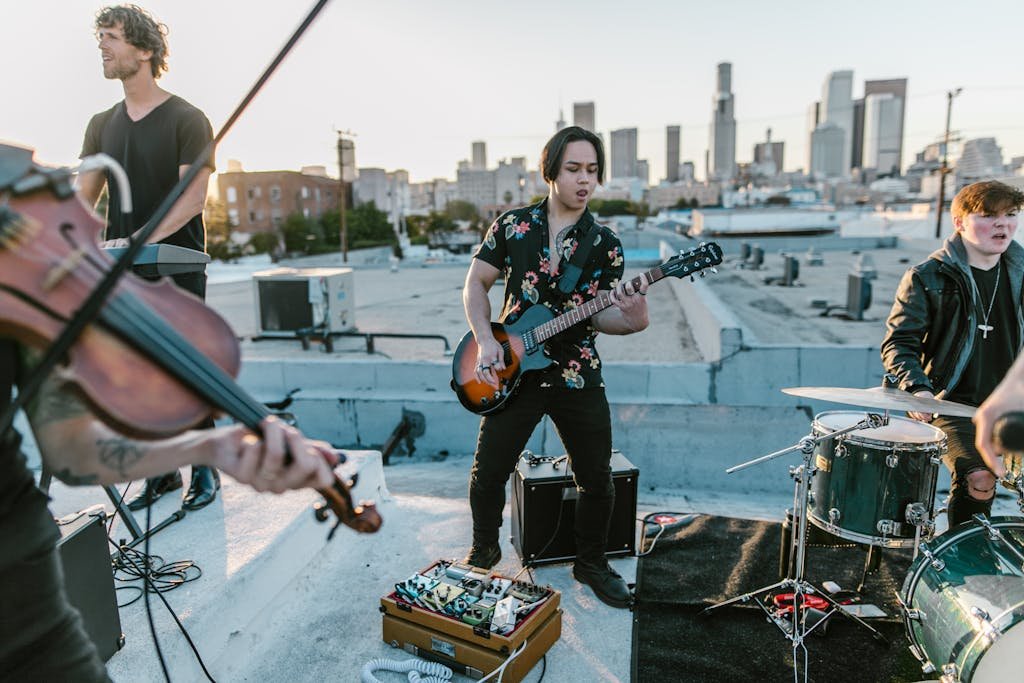 Man in Black and White Floral Button Up Shirt Playing Electric Guitar