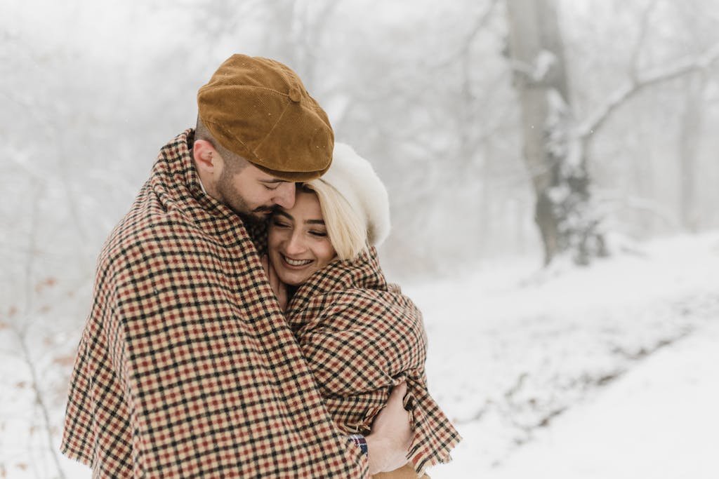 A Couple Hugging Under a Blanket