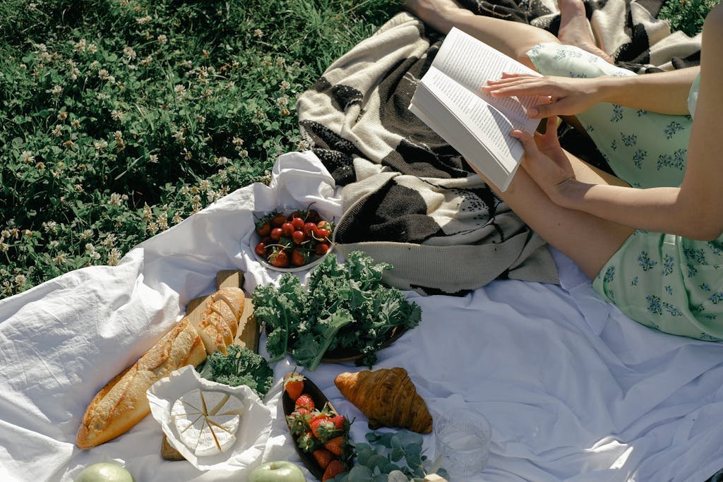 A Woman on the Picnic Blanket While Reading a Book