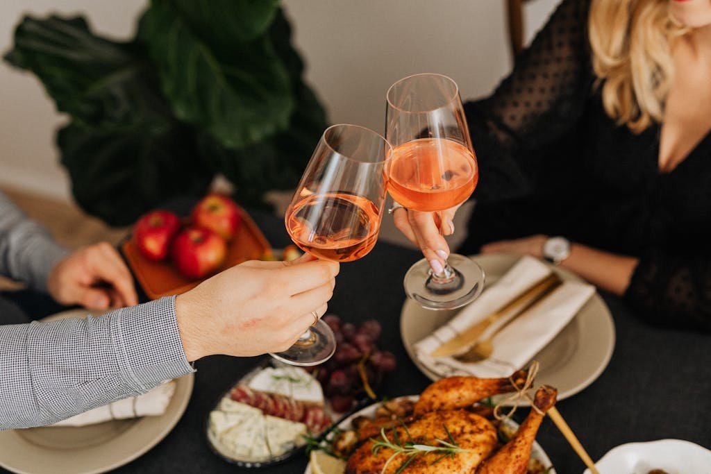 Man and Woman Clinking Glasses with Wine During Dinner - married date night questions