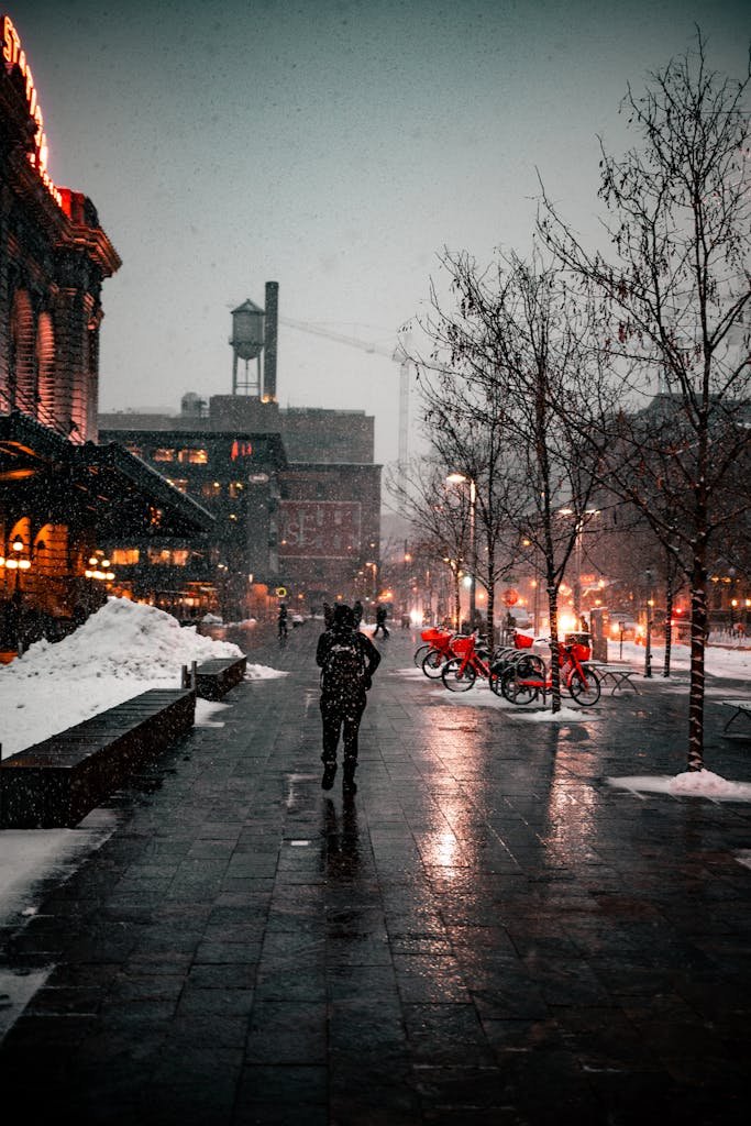 A person walks through snowy downtown Denver, capturing urban winter vibes.