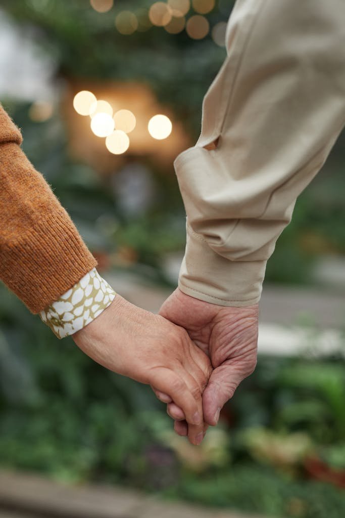 Intimate close-up of a senior couple holding hands, symbolizing love and togetherness.