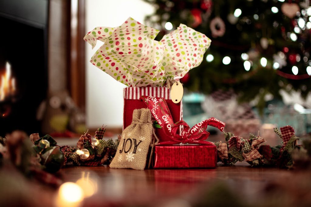 Warm holiday scene with decorated gifts under a Christmas tree.