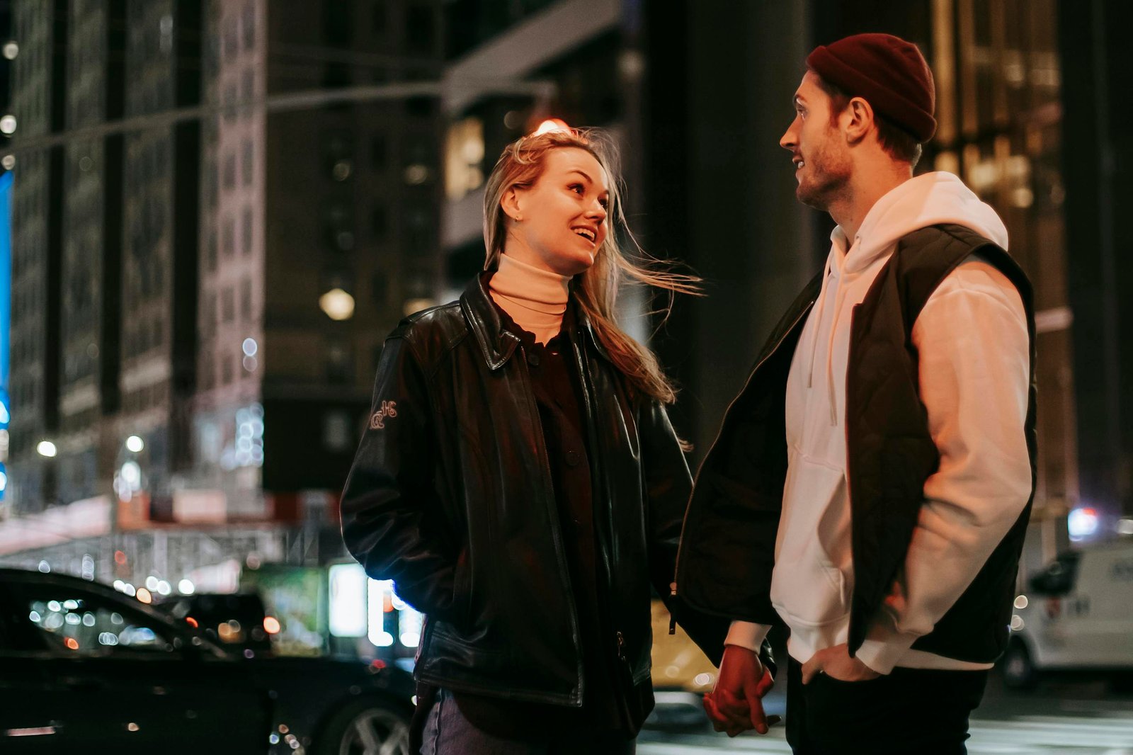 A couple enjoying a romantic evening in the vibrant city streets, capturing love and urban nightlife.