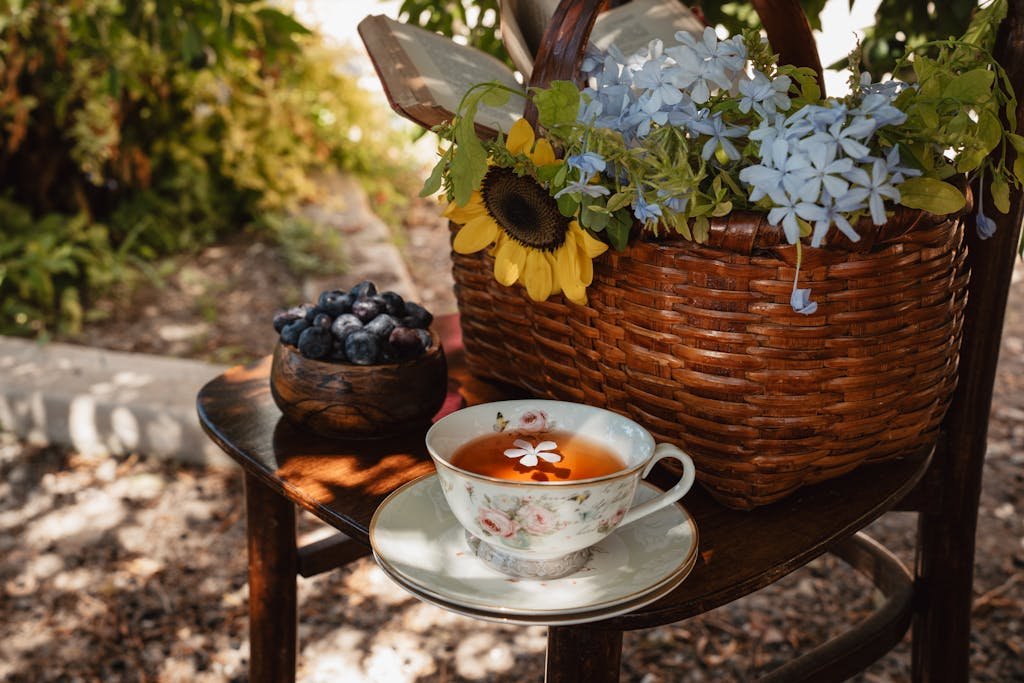 A serene outdoor tea setup with berries and vibrant flower arrangement.