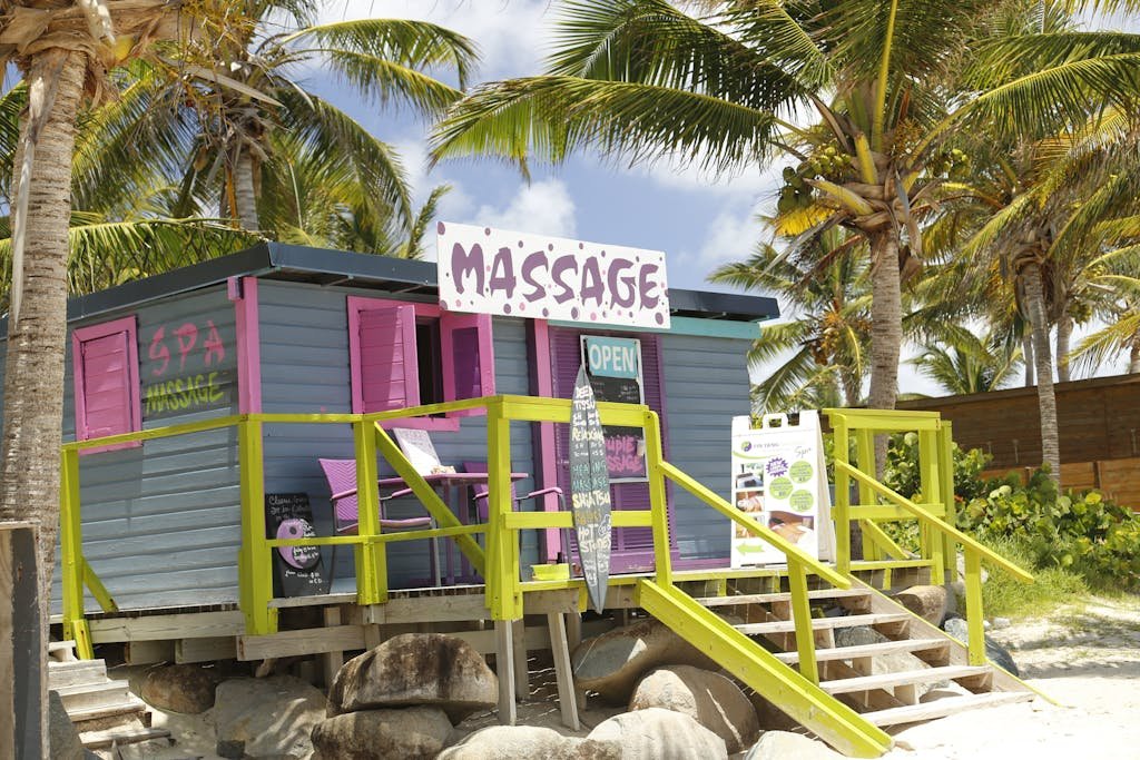 A vibrant beachside spa shack surrounded by palm trees in Saint Martin.