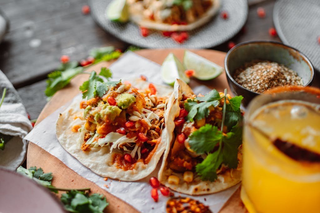 Delicious Mexican street tacos served with fresh ingredients and a citrus beverage.