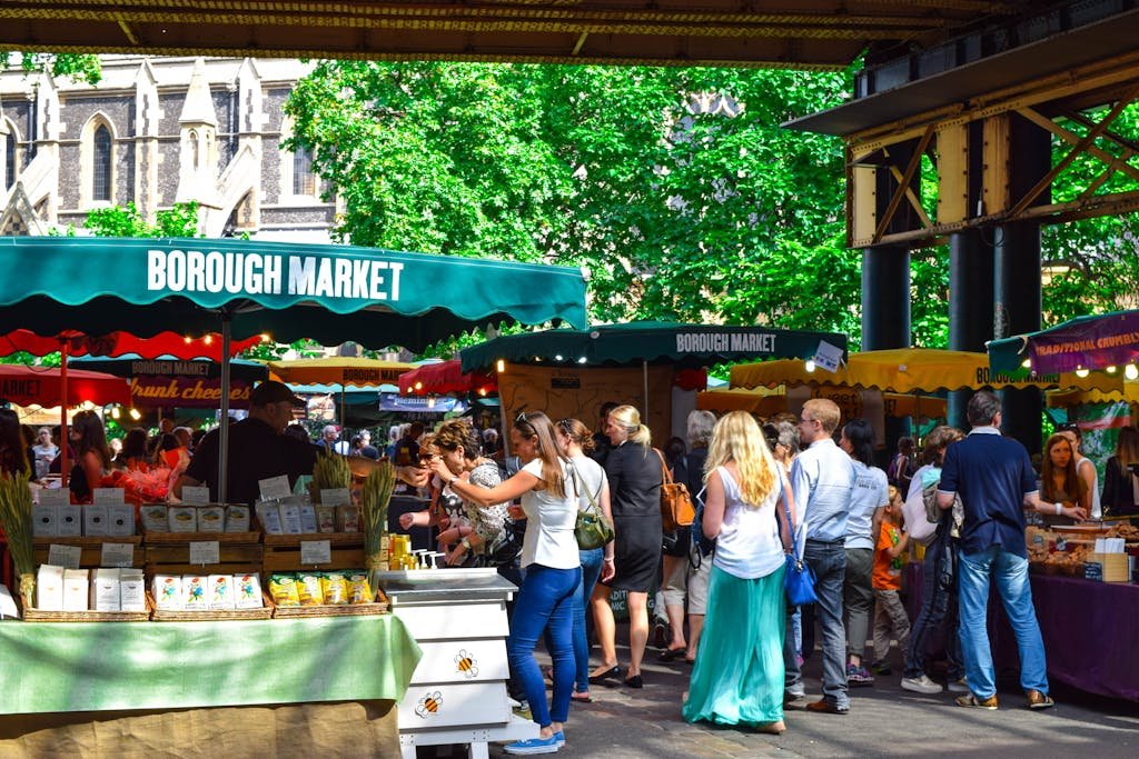 Lively scene at Borough Market in London, filled with people shopping and enjoying the atmosphere.