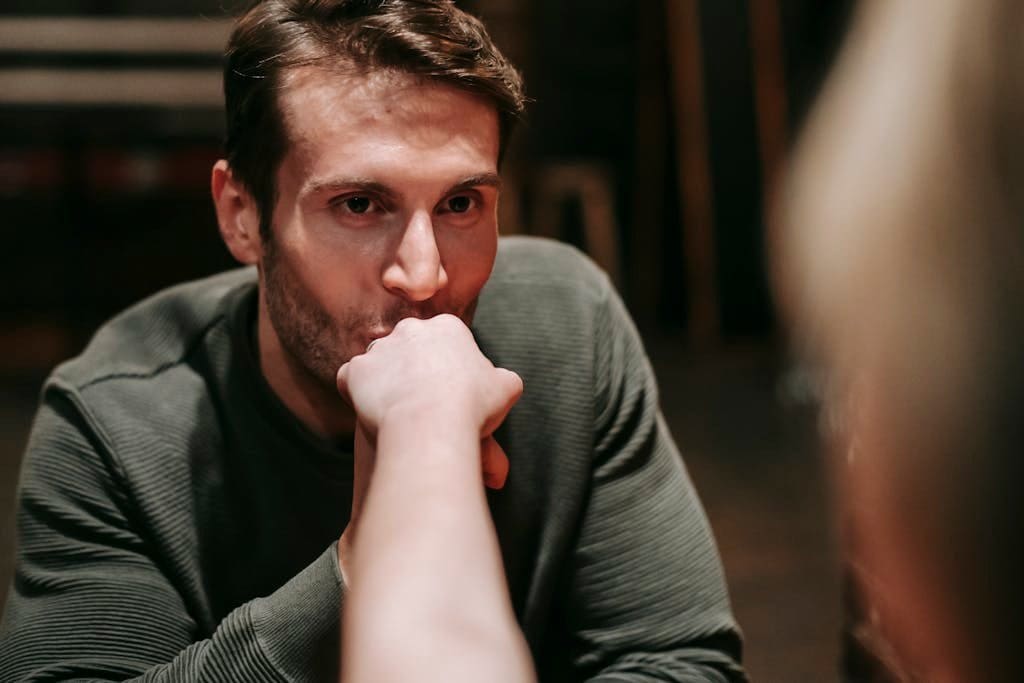 Plan a Fun Escape Room Date at Home 1 A man gently kisses a woman's hand in a cozy indoor setting, reflecting tender affection.
