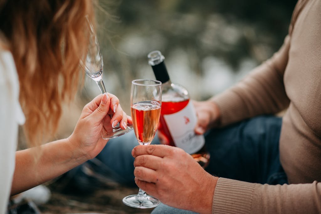 Budget-Friendly Activities for Couples That Feel Special 2 Couple enjoying a romantic outdoor picnic with rose wine, celebrating togetherness.