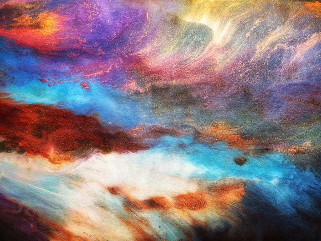 Dynamic abstract art with vivid blues, purples, and oranges creating a mesmerizing visual impact.