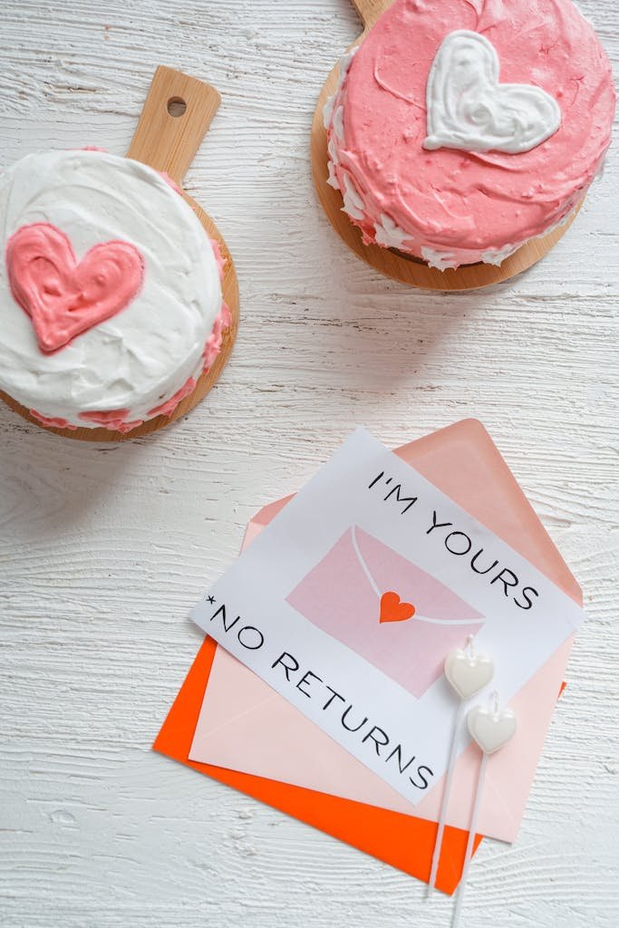 The Secret to Sticking With Weekly Date Nights 2 Heart-shaped cakes and a love note on white background, perfect for romantic occasions.